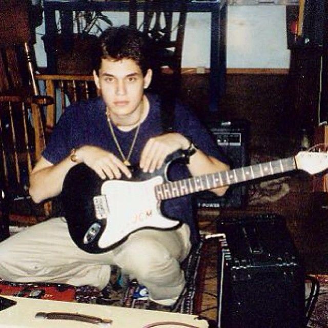 John Mayer as a teen holding a guitar.