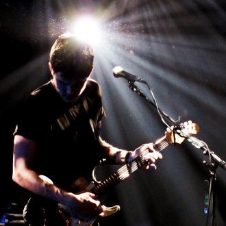 John on stage with spotlight.